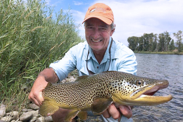Smiling Man with Brown Trout on Snake River Guided Fishing Trip